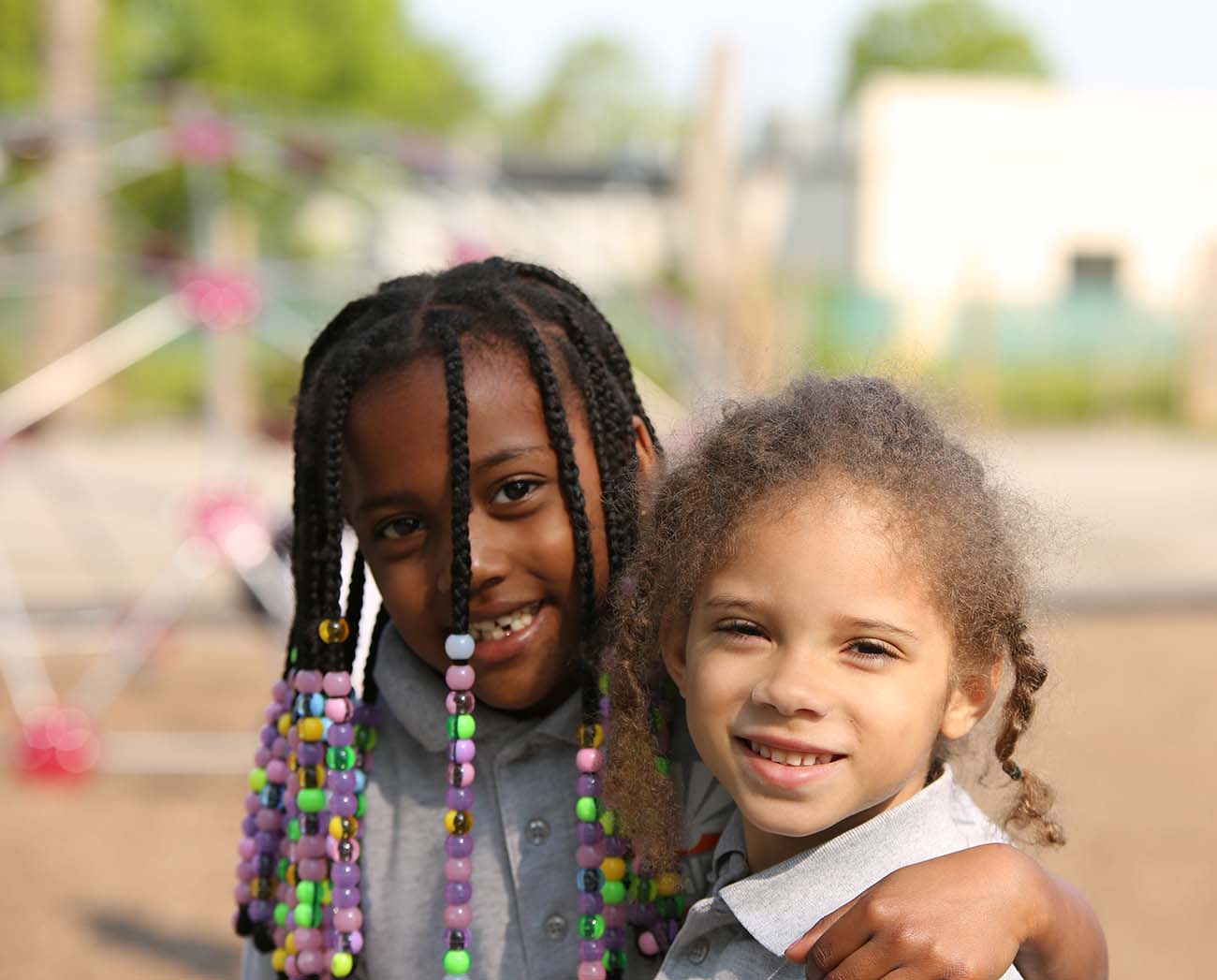Smiling children together outdoors.