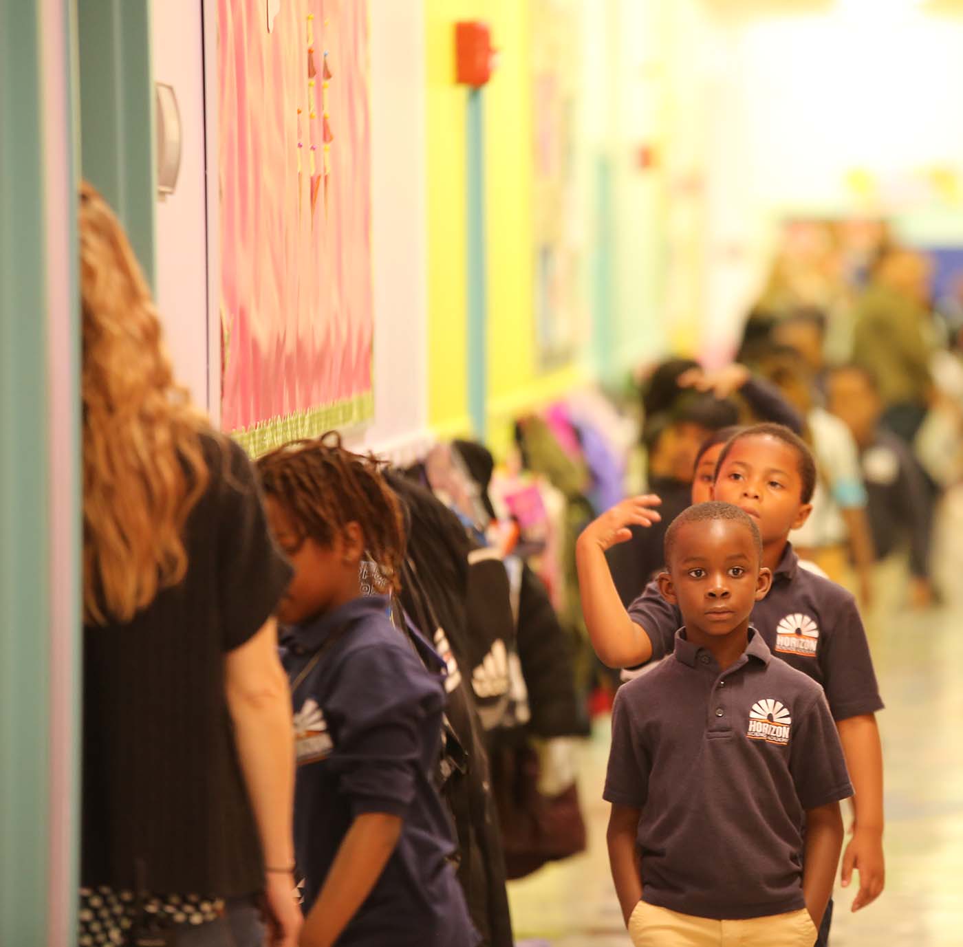 HSA Columbus Primary student drawing at a desk in a classroom setting